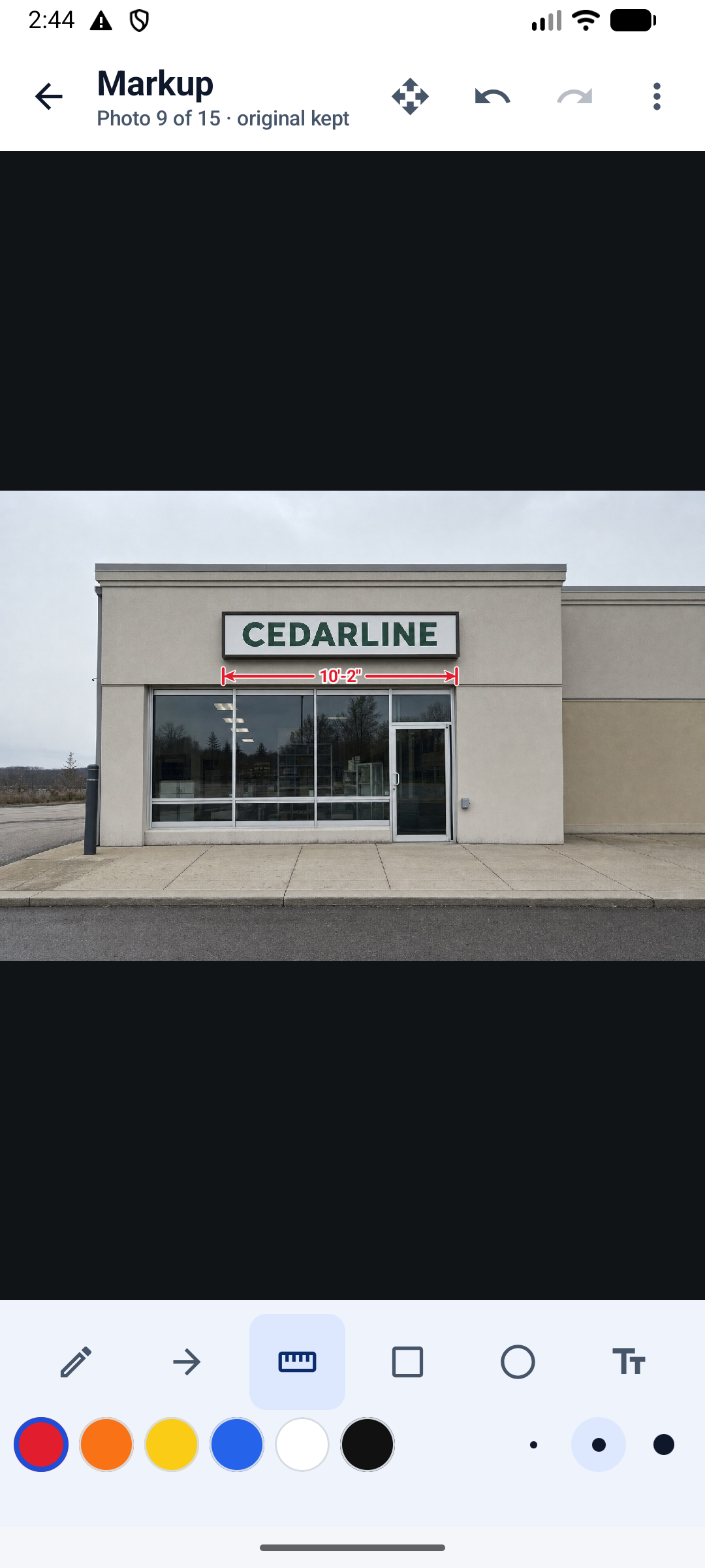 The FieldJot markup editor with the measurement tool selected: a dimension line labelled 10 feet 2 inches drawn across a storefront sign